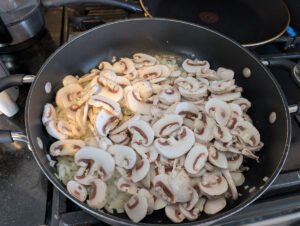 Sauteeing the mushrooms with garlic and onions!