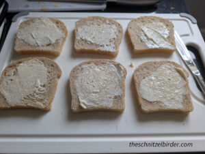 Applying the mayo to the bread