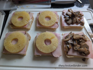 Putting the pineapple or mushrooms on the ham and bread